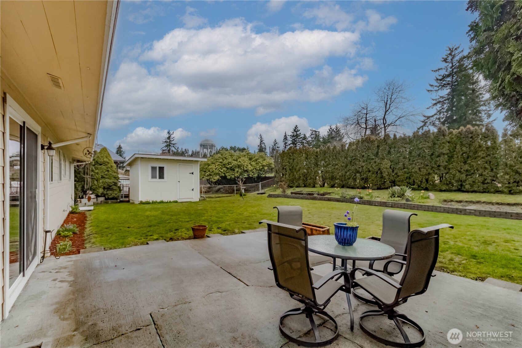 1060 Lynnwood Avenue Northeast Renton, WA 98056 - Photo 35 of 40 a view of a swimming pool and lounge chairs in back of the house
