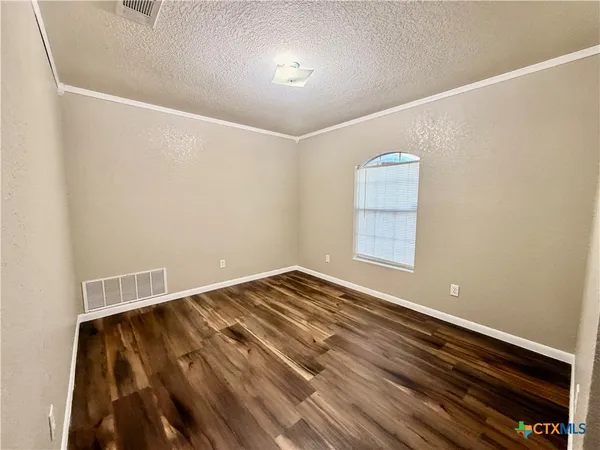 a view of room with window and ceiling fan