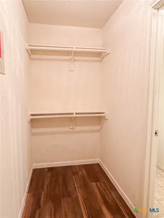 a view of a room with wooden floor