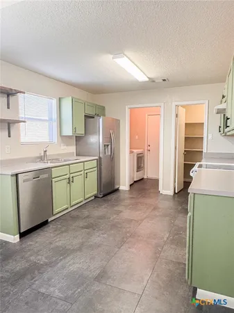 a utility room with a sink a washer and dryer