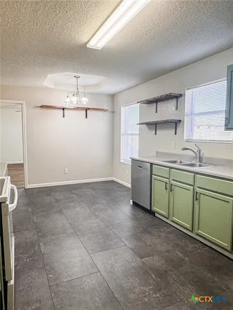 a kitchen with a sink cabinets and window