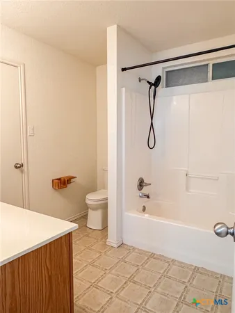 a bathroom with a shower and a bath tub