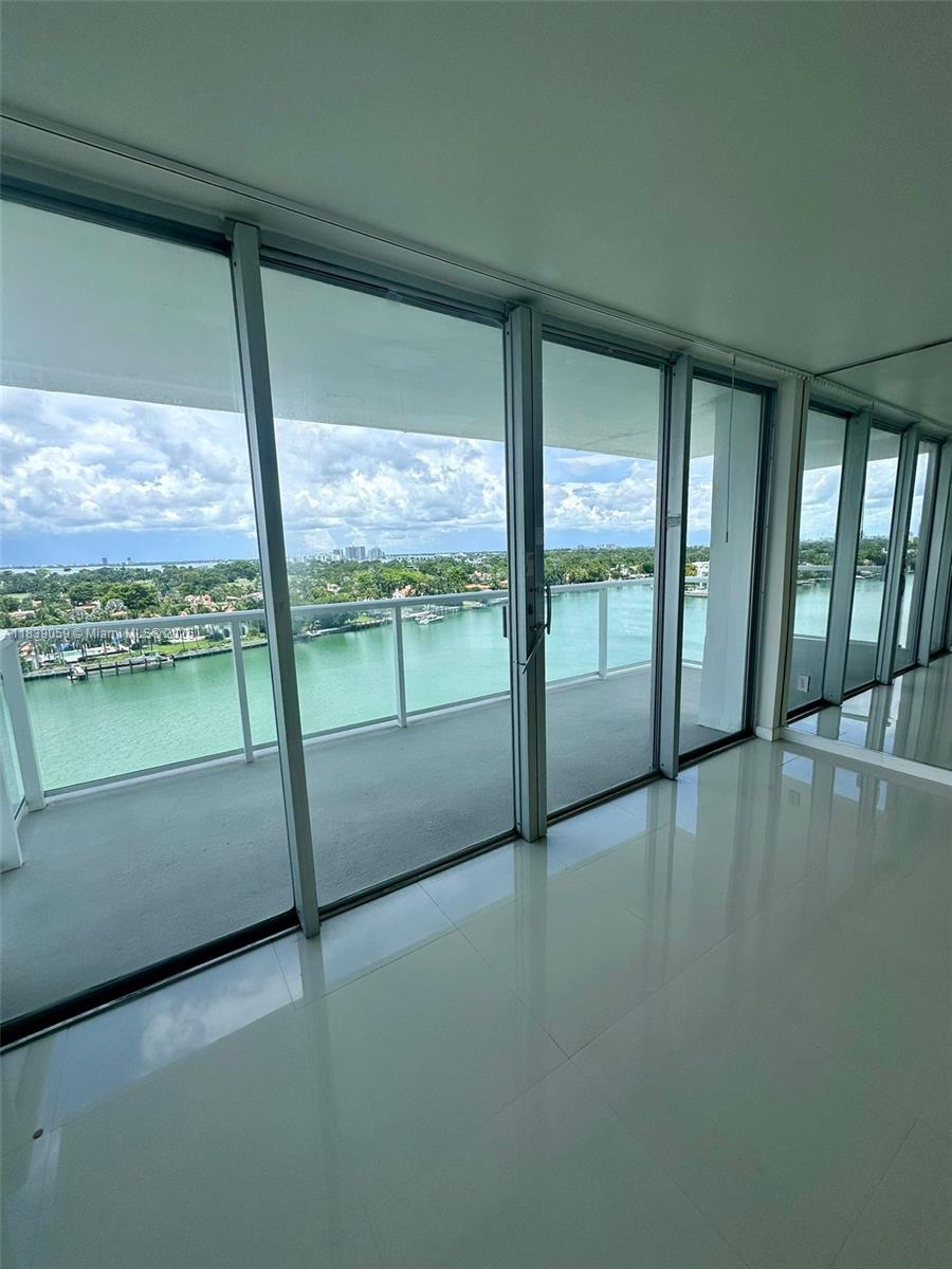 a view of an empty room with a floor to ceiling window