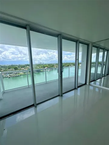 a view of an empty room with a floor to ceiling window