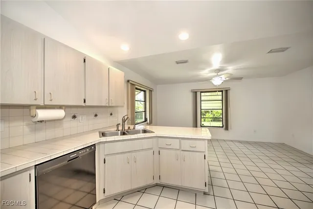 a kitchen with a sink cabinets and window
