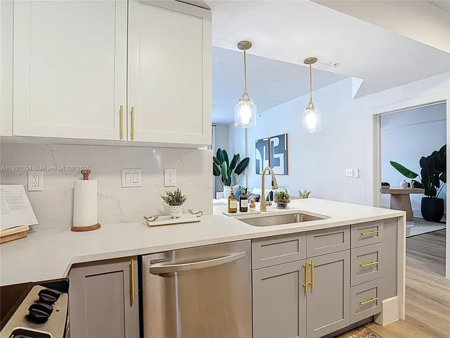 a kitchen with sink and cabinets
