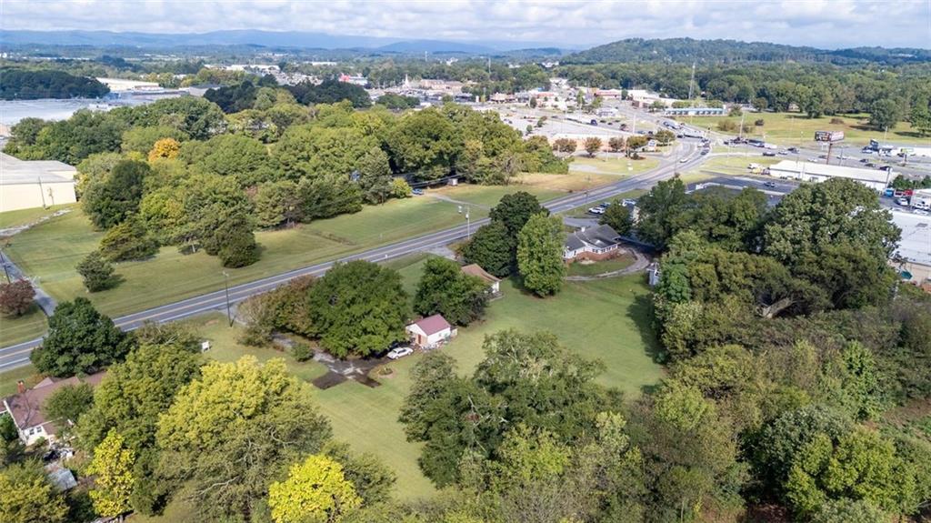 1316 Highway 41 Calhoun, GA 30701 - Photo 2 of 13 an aerial view of green landscape with trees houses and mountain view