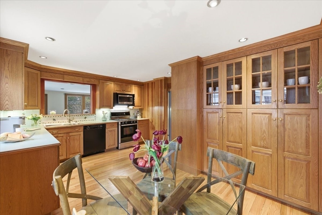 238 Harris Avenue Needham, MA 02492 - Photo 13 of 35 a view of a dining room with furniture a kitchen and chandelier