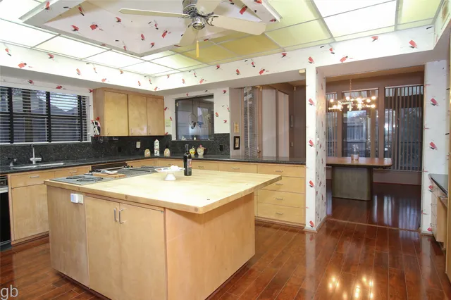a kitchen with stainless steel appliances granite countertop a sink and a stove