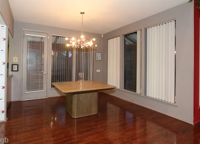 a room with pool table and windows