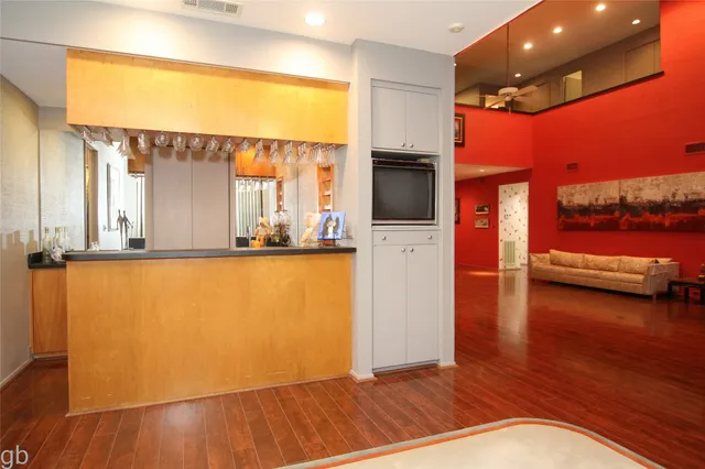 a view of a living room with kitchen furniture and a flat screen tv