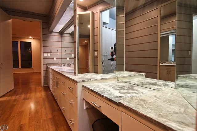 a bathroom with a granite countertop sink and mirror