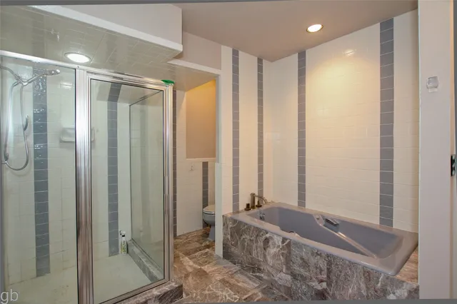 a bathroom with a tub and shower
