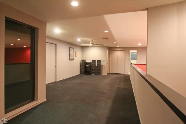 a view of a hallway with seating area