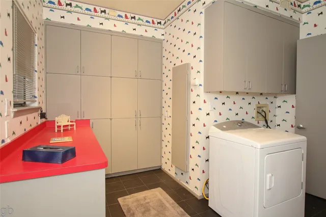 a room with a sink and cabinets