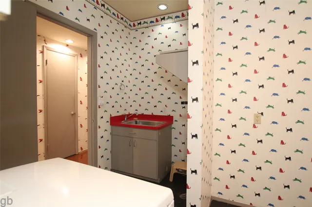 an aerial view of house with yard and trees in the background