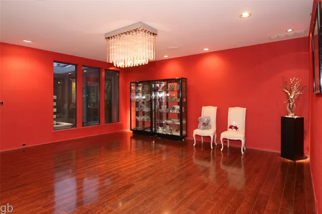 a view of a room with wooden floor and a chandelier