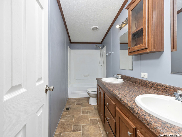 135 Savannah Ridge Von Ormy, TX 78073 - Photo 13 of 45 a bathroom with a granite countertop sink a mirror and a toilet