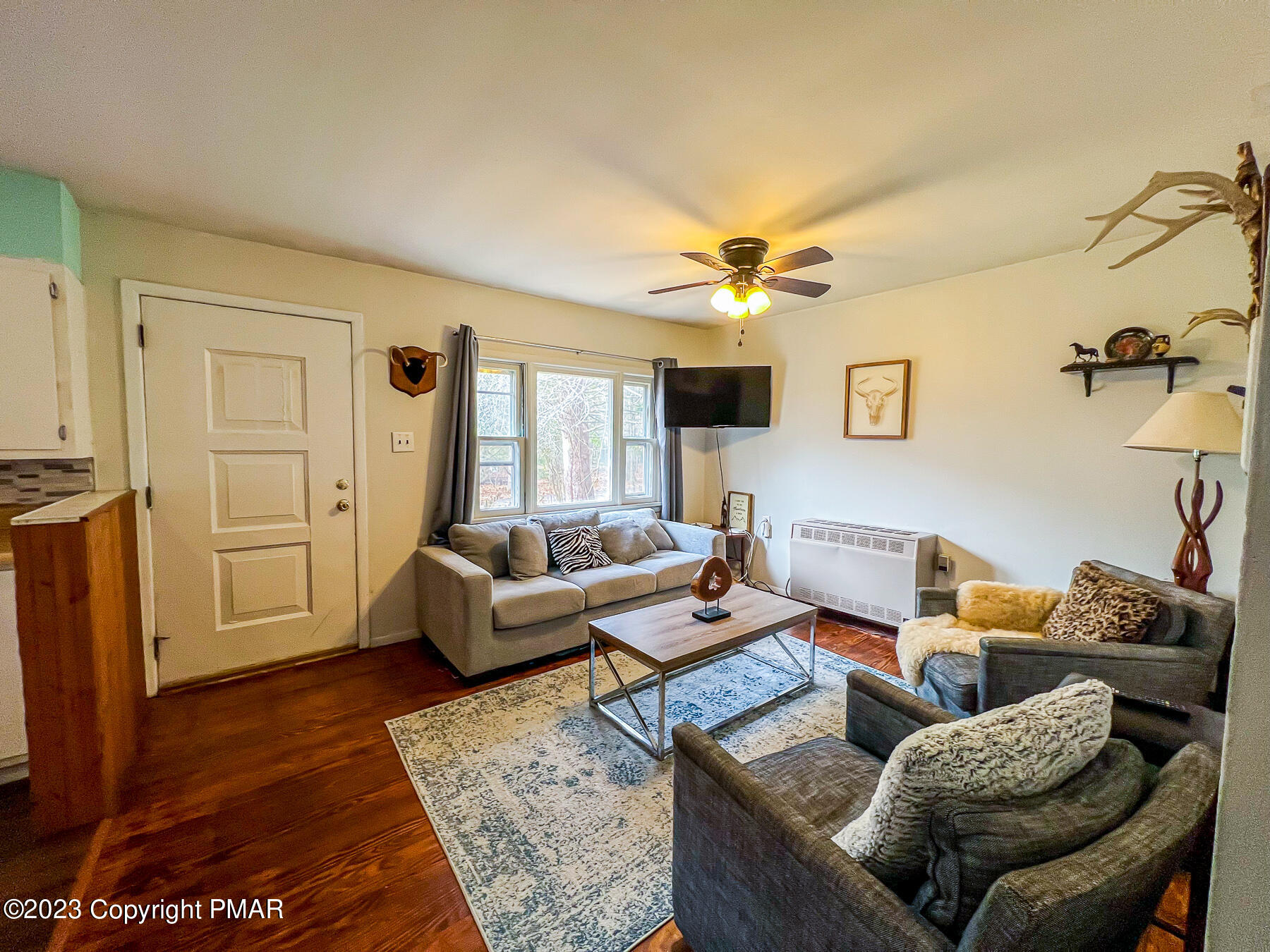 216 Sutton Place Pocono Summit, PA 18346 - Photo 12 of 34 a living room with furniture and a rug