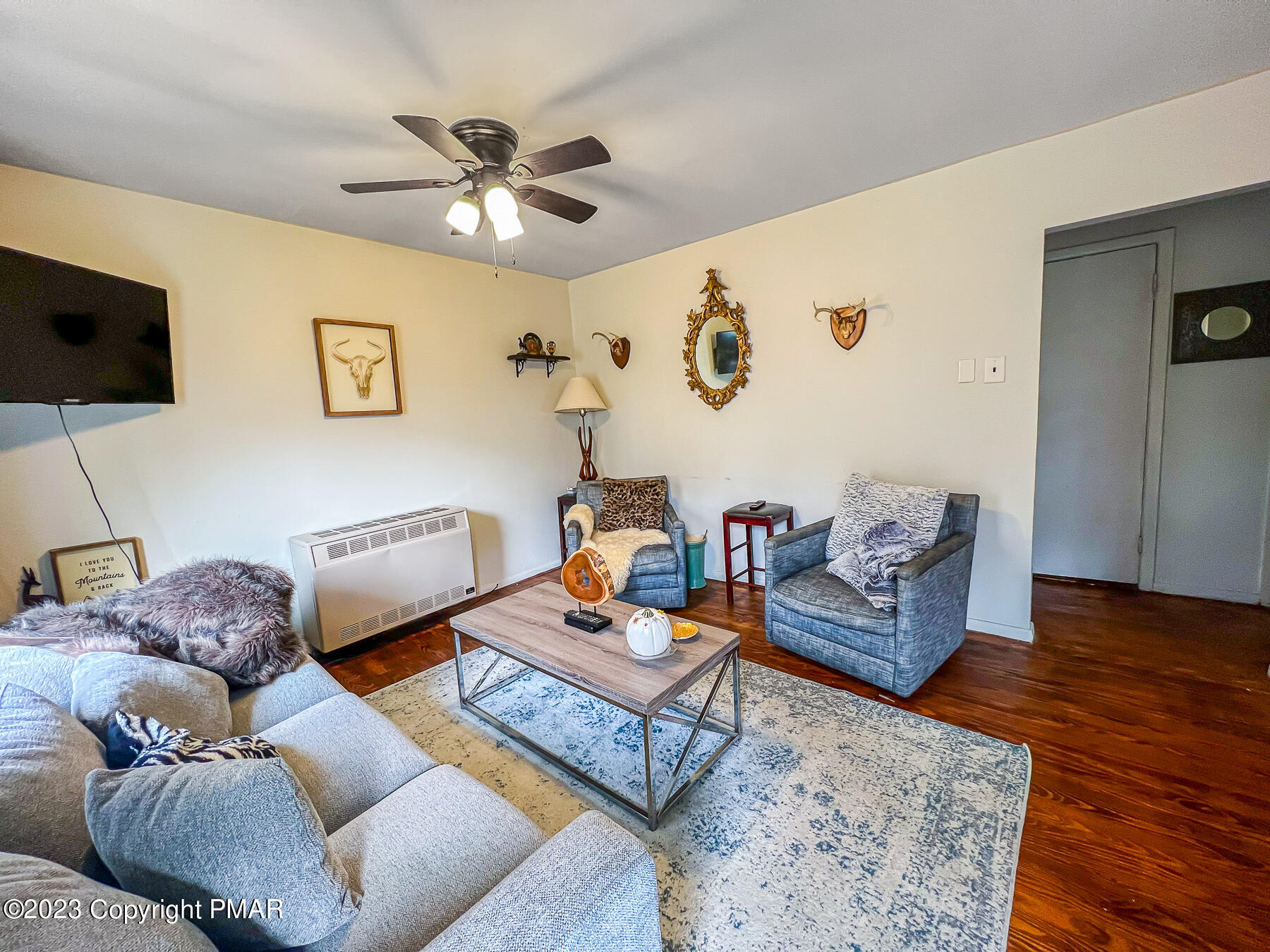 216 Sutton Place Pocono Summit, PA 18346 - Photo 13 of 34 a living room with furniture and a wooden floor