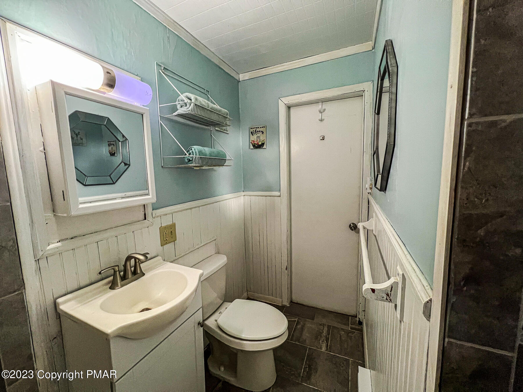 216 Sutton Place Pocono Summit, PA 18346 - Photo 21 of 34 a bathroom with a toilet sink and mirror