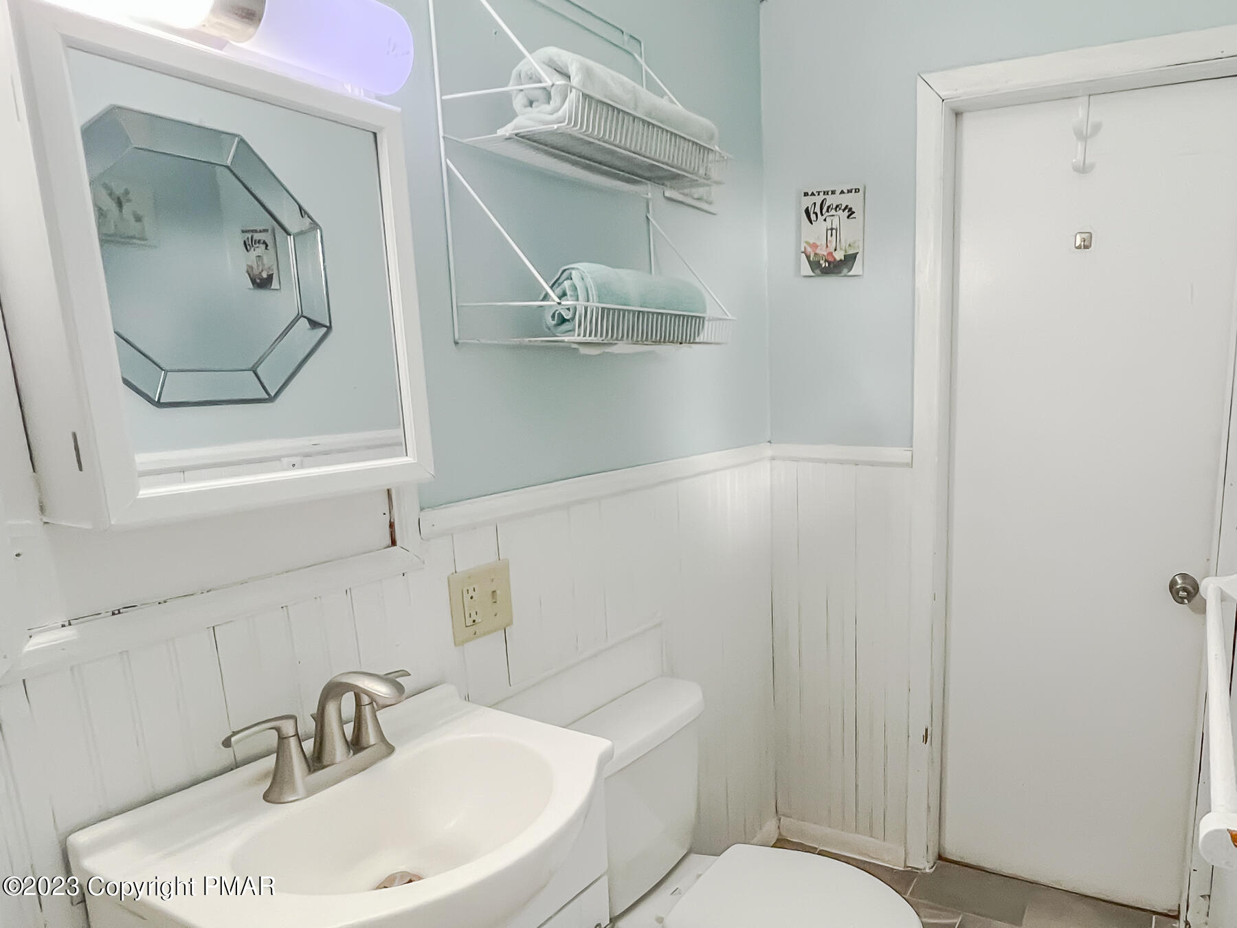 216 Sutton Place Pocono Summit, PA 18346 - Photo 23 of 34 a bathroom with a sink mirror and toilet
