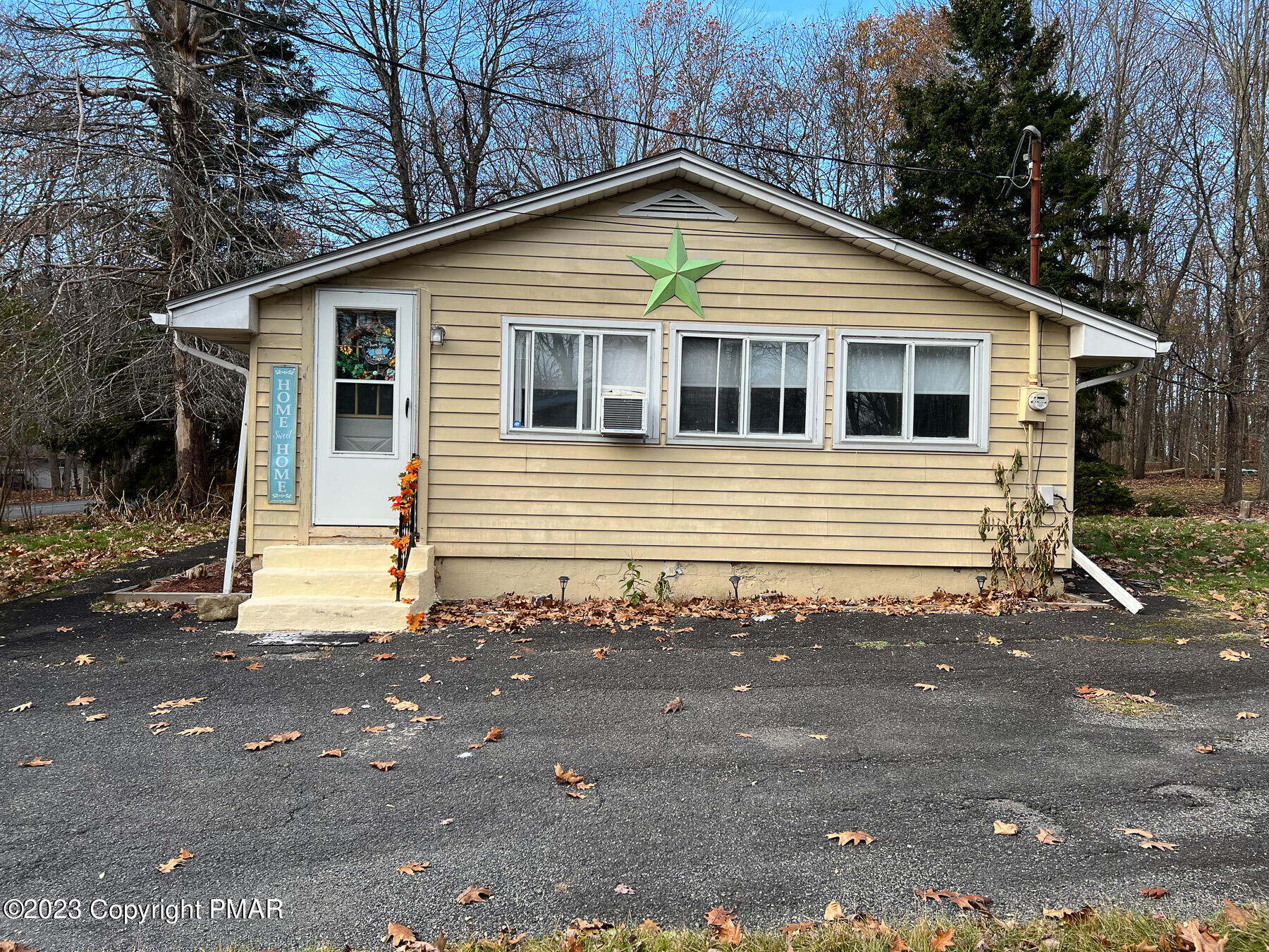 216 Sutton Place Pocono Summit, PA 18346 - Photo 27 of 34 a front view of a house with a yard