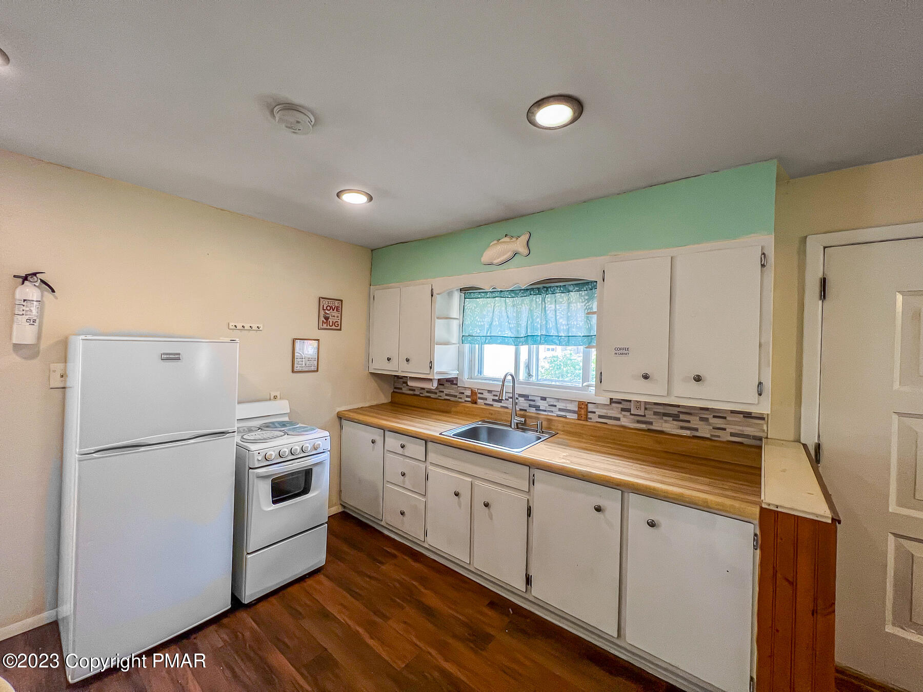 216 Sutton Place Pocono Summit, PA 18346 - Photo 7 of 34 a kitchen with a sink a refrigerator and window