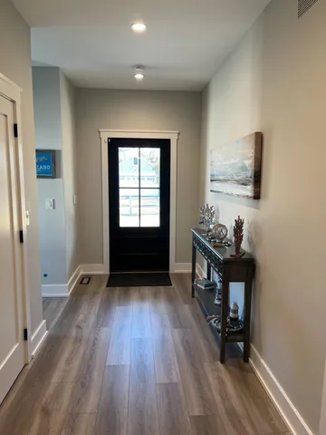 a view of room with window and wooden floor