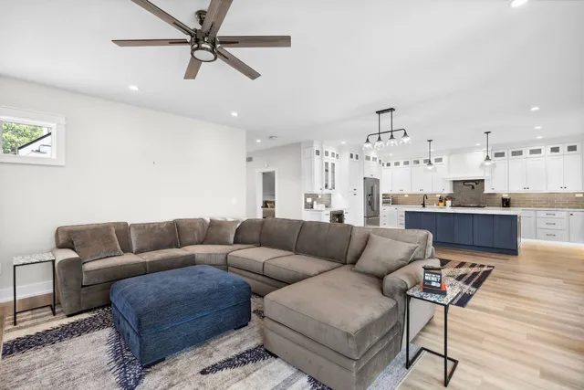 a living room with furniture and kitchen view