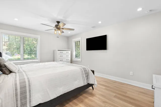 a bedroom with a bed and a flat screen tv