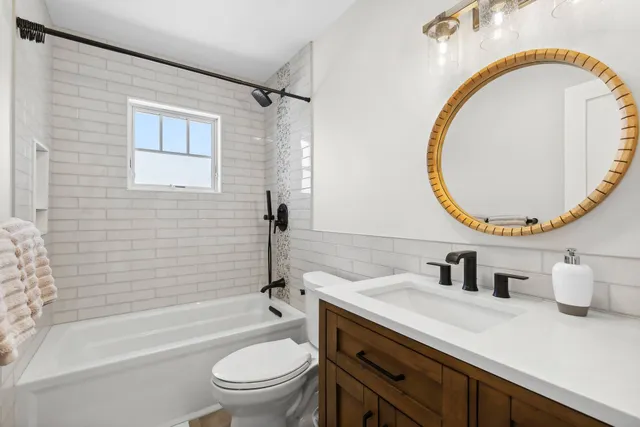 a bathroom with a sink a toilet and a mirror