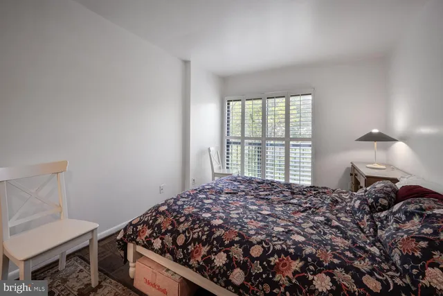 a bed sitting in a bedroom next to a window