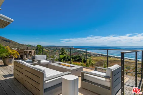 a view of a patio with couches table and chairs