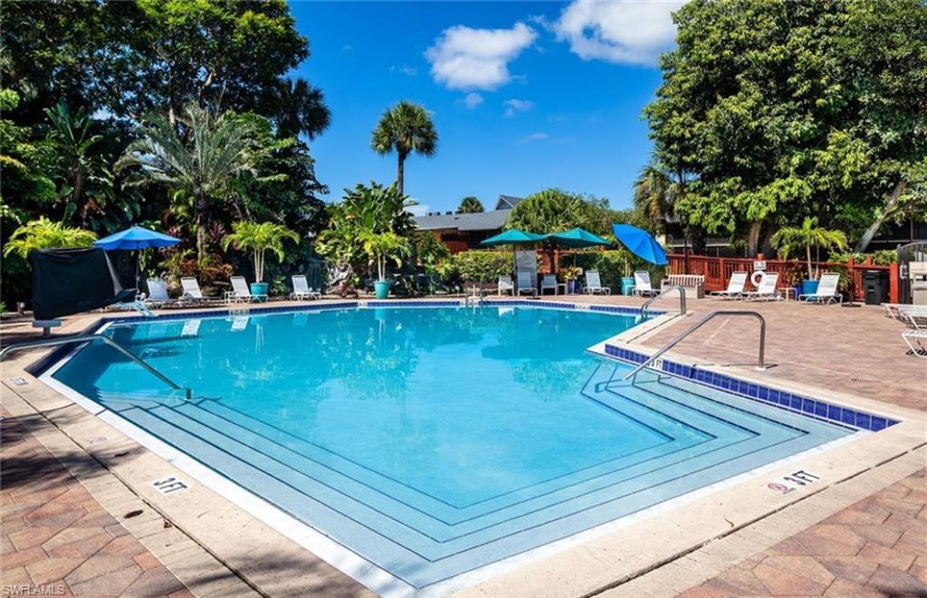 600 Neapolitan Way, Unit 152 Naples, FL 34103 - Photo 21 of 41 a view of a swimming pool with an outdoor seating
