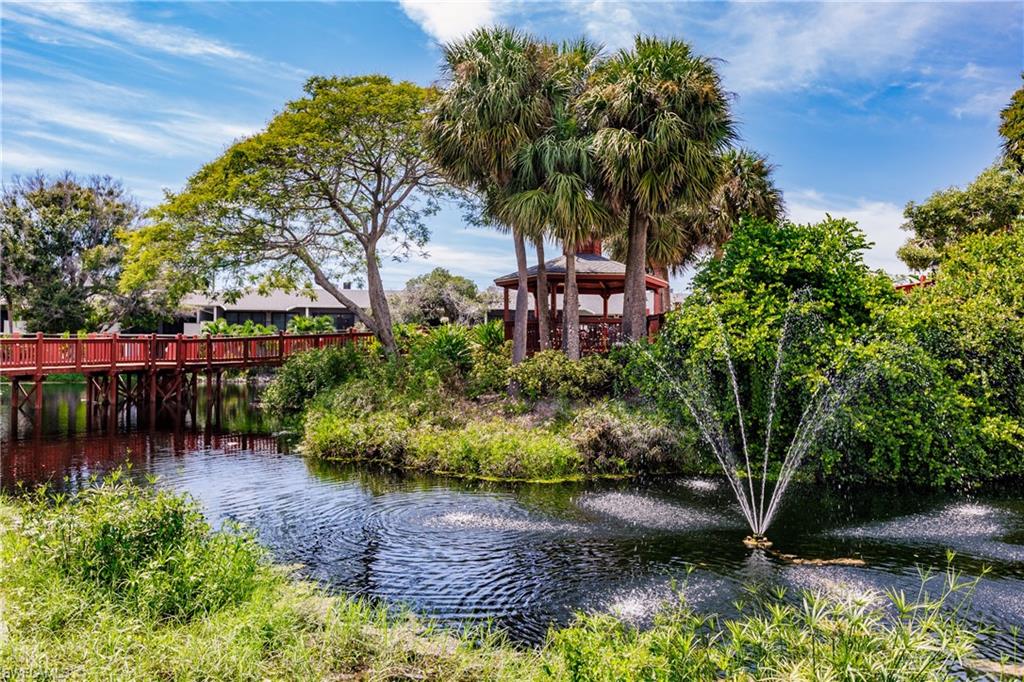 600 Neapolitan Way, Unit 152 Naples, FL 34103 - Photo 39 of 41 a view of a garden with a bench