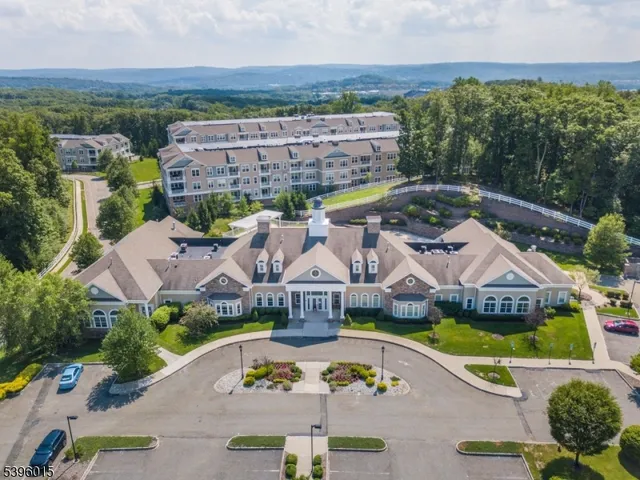 a room with lots of tables a dining table and a chandelier