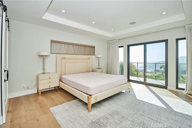 a bedroom with a large bed and a large window