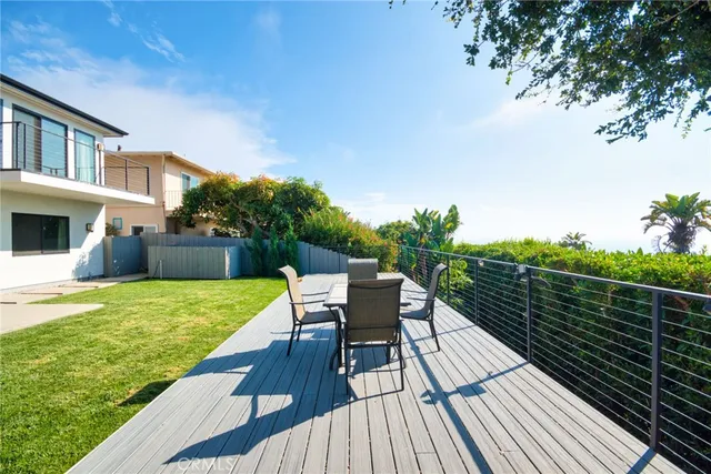 a view of a balcony with wooden floor and fence