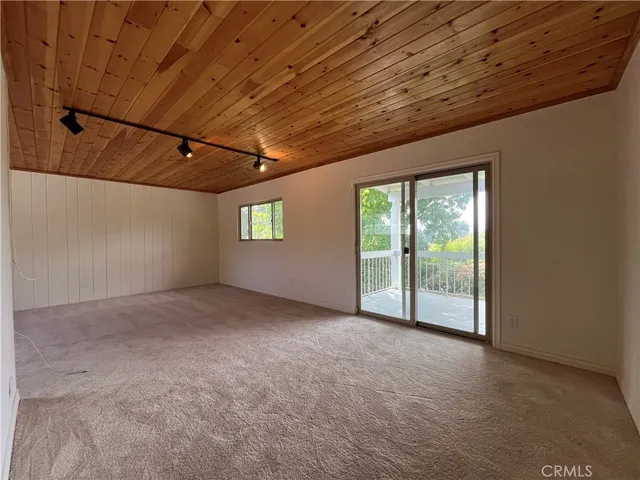 a view of a livingroom with an empty space and a window
