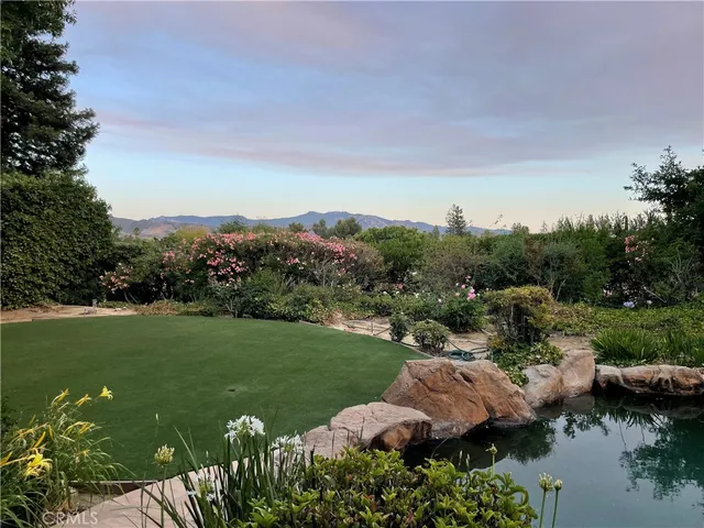 a view of a lake with houses in back