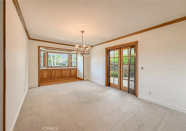 a view of an empty room with a window and fireplace