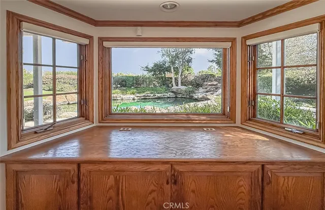a bathroom with a granite countertop sink and large window