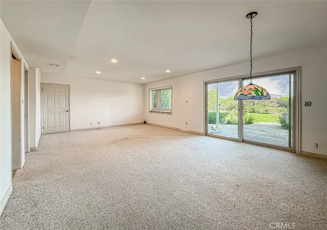 a view of an empty room with windows and outdoor view