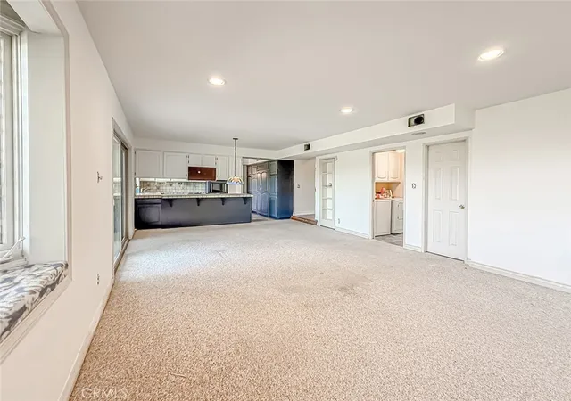 a large room with closet and windows