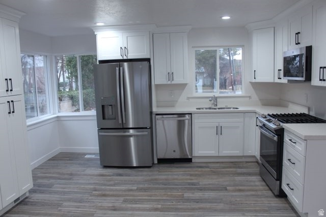 545 100 East Bountiful, UT 84010 - Photo 4 of 17 Kitchen featuring stainless steel appliances, white cabinetry, and light wood-type flooring