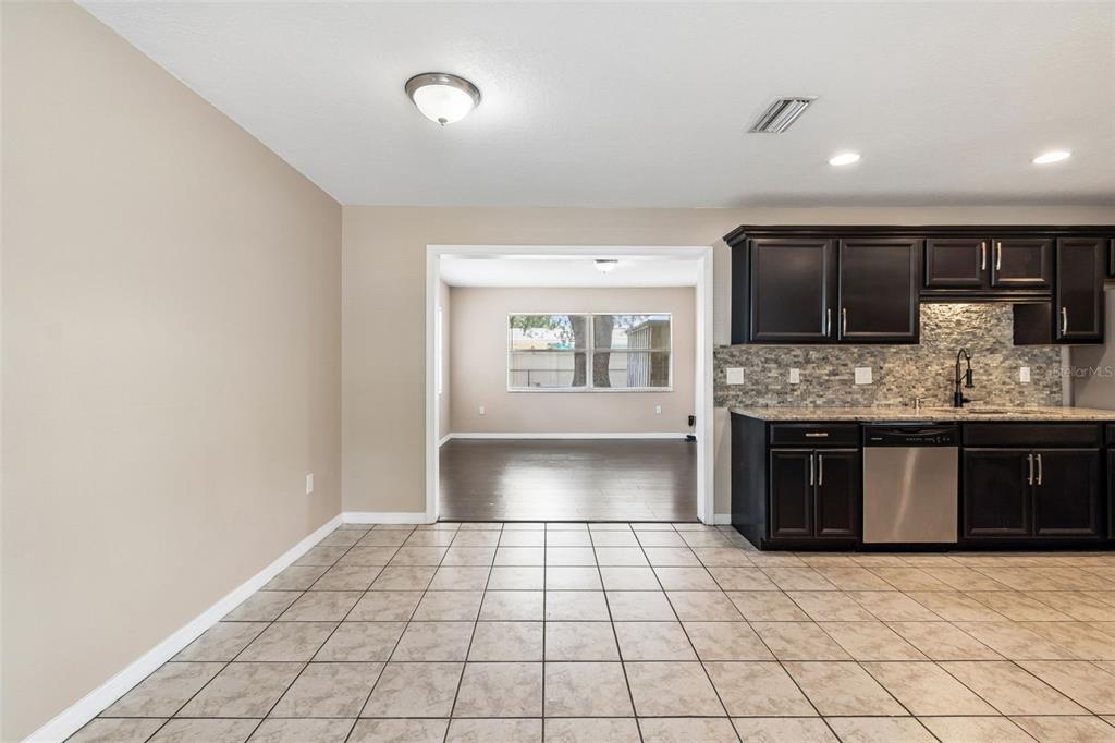 4018 Prado Drive Sarasota, FL 34235 - Photo 17 of 74 a kitchen with granite countertop a stove a sink and a microwave