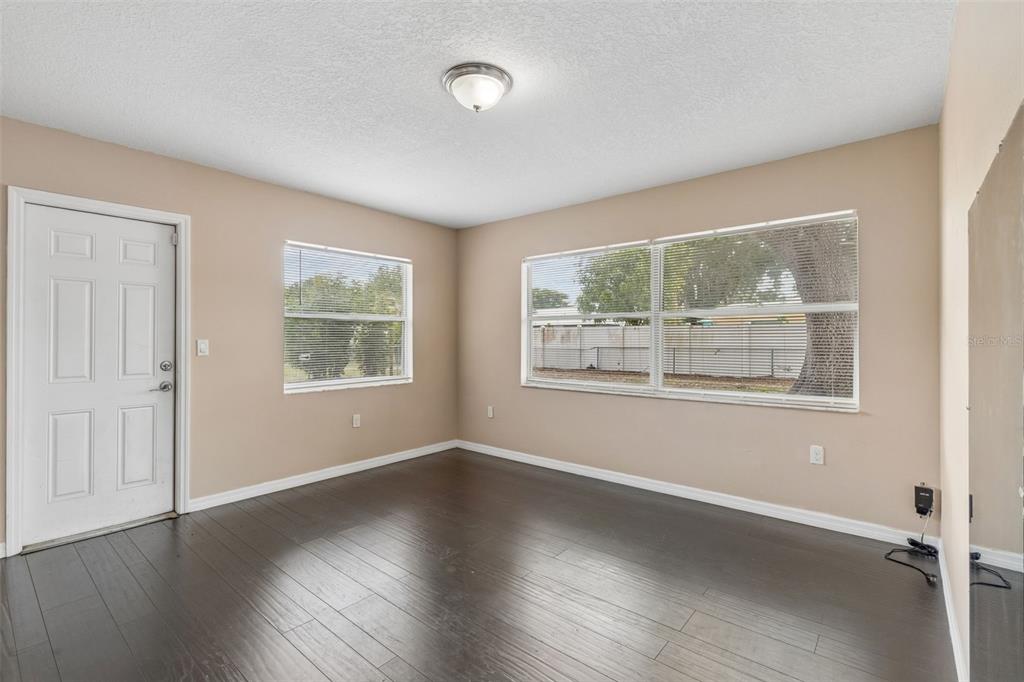 4018 Prado Drive Sarasota, FL 34235 - Photo 30 of 74 a view of an empty room with wooden floor and a window