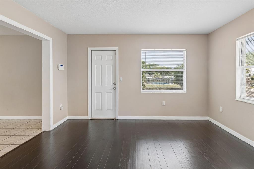 4018 Prado Drive Sarasota, FL 34235 - Photo 32 of 74 a view of an empty room with wooden floor and a window
