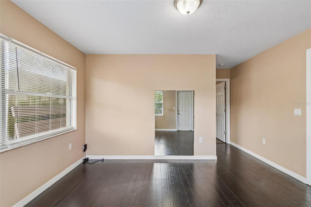 4018 Prado Drive Sarasota, FL 34235 - Photo 33 of 74 an empty room with wooden floor and windows